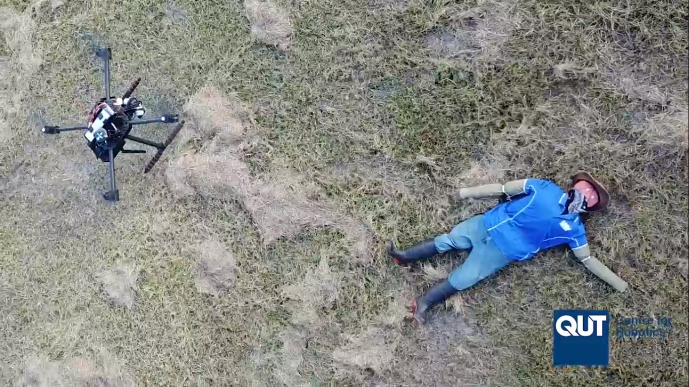 UAV flying low over a mannequin used for human-detection field tests